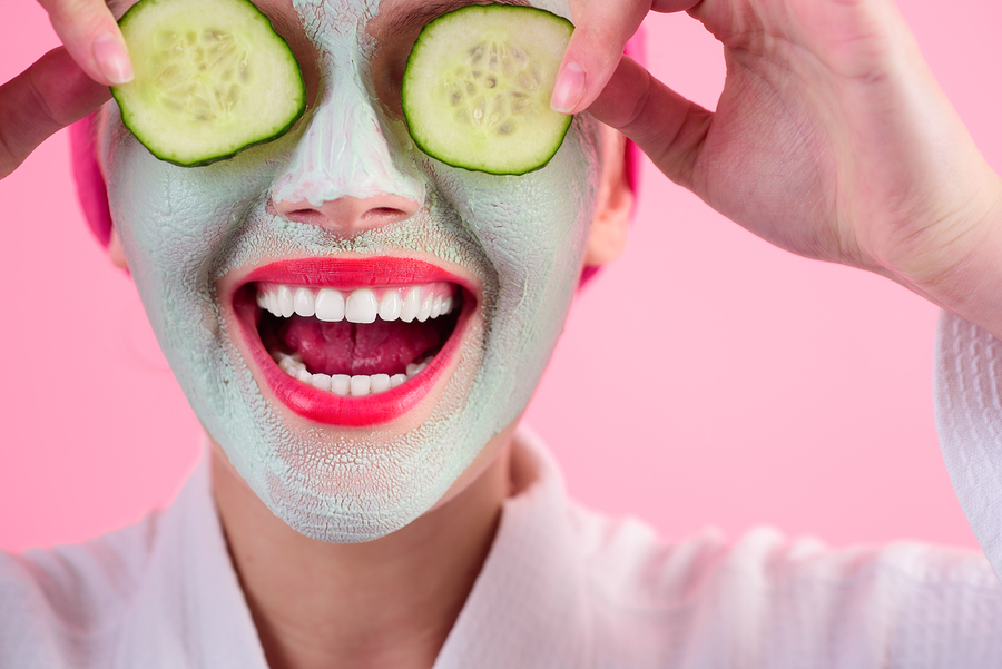 Close Up Portrait Of Woman With Facial Cosmetical Mask And Cucum